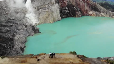 Aerial View of Friends Overlooking Java Indonesia Sulfur Volcano Kawah Ijen Stock Footage 142304825