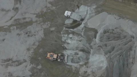 Aerial view of a front end loader working in a gravel quarry Видео 343843861