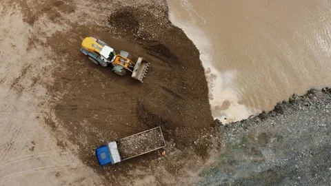 Aerial view of a front end loader loading a dump truck at a quarry Stock-Footage 344656684