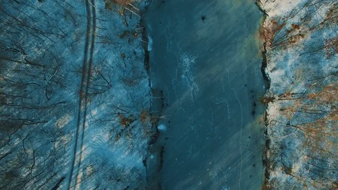 Aerial view on frozen lake at winter forest drone footage Stock Footage 86181663