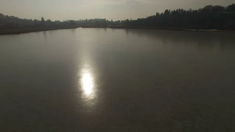 Aerial view of frozen surface of small lake in Italy at the sunset Video stock 72107132