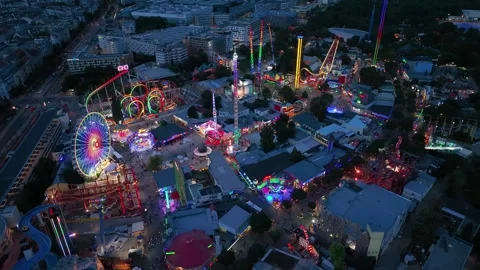 Aerial view fun fair. Twilight time illumination Vienna city park Prater Stock Footage 241441037