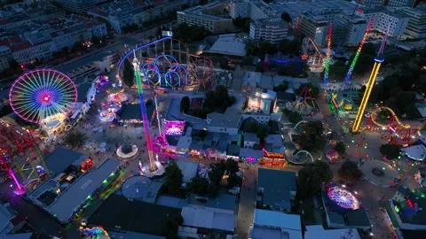 Aerial view fun fair. Twilight time illumination Vienna amusement park Prater Stock Footage 243543216
