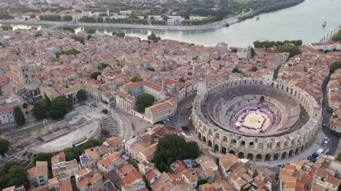 Aerial view of functioning restored antique Roman amphitheatre and ruins of Stock Footage 166177559