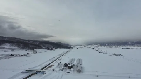 Aerial View of Furano Snow Fields and Mountains in Winter Stock Footage 334454735