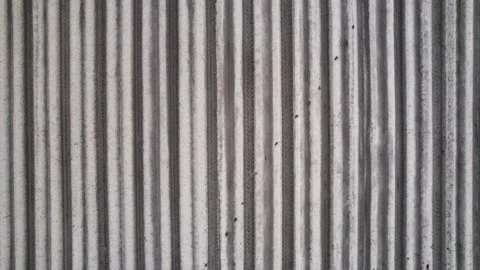 Aerial view of furrows on raw plowed field Stock Footage 155148937