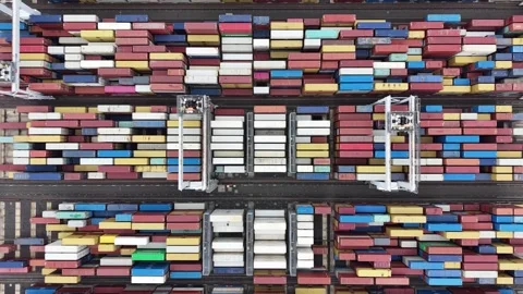 Aerial view of gantry cranes moving shipping containers at port terminal Stock-Footage 337811310