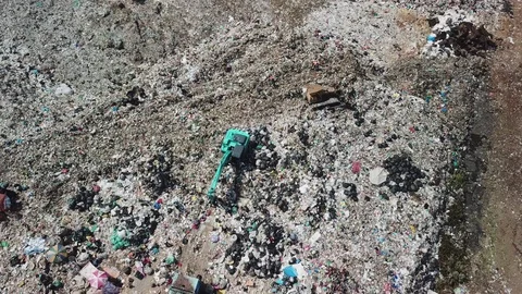 Aerial view of garbage on the city dump truck working in landfill. Consumerism a Stock Footage 125283505
