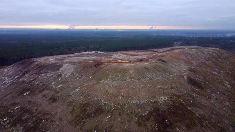 Aerial View of Garbage Dump and City behind it. Video stock 143614705