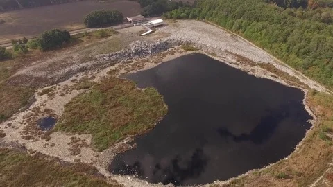 Aerial view. Garbage Dump near a small lake with black water Stock-Footage 71379272