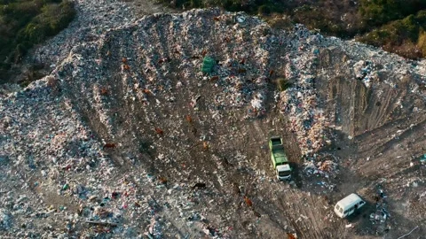 Aerial view of garbage pile in trash dump with dump track unload garbage at Stock Footage 267977068