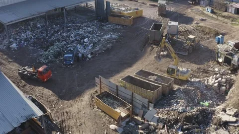 Aerial view of garbage sorting station with trucks and excavator Видео 274048126