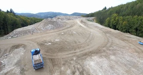 Aerial view garbage trucks unload garbage to a landfill. Plastic  crisis. Stock Footage 120942957