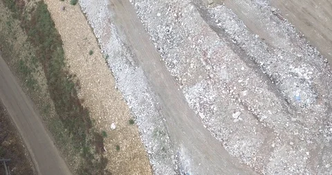 Aerial view garbage trucks unload garbage to a landfill. Plastic  crisis. Stock Footage 120943190