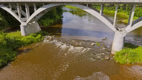 Aerial view of the Gauja River rapids under Sigulda bridge in Latvia, with Stock Footage 340919851