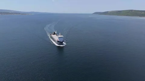 Aerial view of general cargo ship transiting calm blue strait Stock Footage 335262894