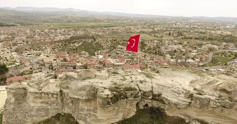 Aerial view, general view of Urgup and Turkish flags, Cappadocia, TURKEY  Stock-Footage 76044971