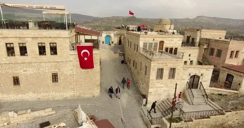 Aerial view, general view of Urgup and Turkish flags, Cappadocia, TURKEY  Stock-Footage 76049371