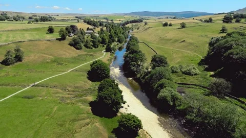 Aerial view of gentle river flowing through green valley Stock Footage 346284208