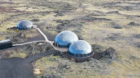Aerial view of geodesic domes in lava field, Iceland. Stock Footage 284853410