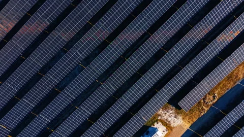 Aerial view of geometric solar panel rows. Symmetrical pattern of dark Stock Footage 329192298