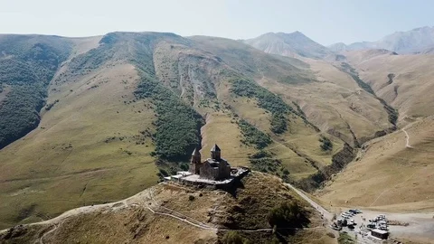 Aerial view of Gergeti Trinity Church, Tsminda Sameba. Kazbegi. Georgia 2017 Stock Footage 106501360
