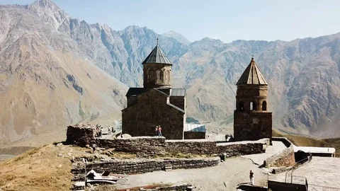 Aerial view of Gergeti Trinity Church, Tsminda Sameba. Kazbegi. Georgia 2017 Stock Footage 106501413