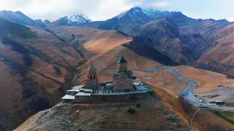 Aerial View of Gergeti Trinity Church in Caucasus Mountains Georgia Video stock 344041365
