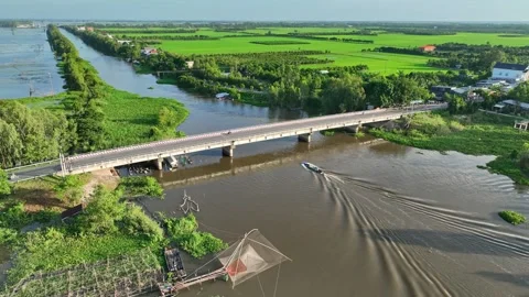 Aerial View of An Giang During Flood Season with Bridge, Boat, Rice Fields, and Stock-Footage 342957604