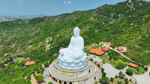 Aerial view of giant Buddha Statue on top of the mountain Stock Footage 297740997