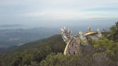 Aerial view of the giant hands cradle Vietnam's Golden bridge on the top of the  Stock Footage