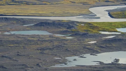 Aerial View of a Glacial River and Rugged Landscape in Iceland Stock Footage 320508438