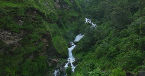 Aerial view of glacial river and waterfall cascading through Himalayan forest Stock Footage 345275465