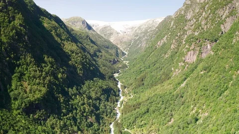 Aerial view of a glacier and stream of  water or river running down a mountain Stock Footage 116861354