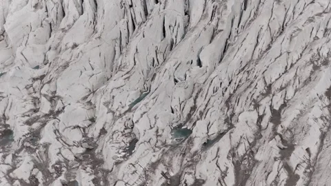 Aerial View of a Glaciers Surface, Highlighting Crevasses and Meltwater Pools Video stock 314458324