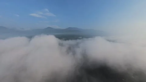 Aerial view glides above thick, swirling clouds Vídeos de archivo 344823218