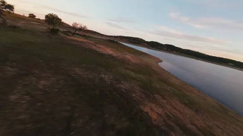 Aerial view glides over calm waters and grassy shorelines Stock Footage 342167155