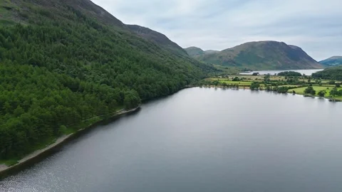 Aerial view glides over calm, mirrored lake Stock Footage 345524452