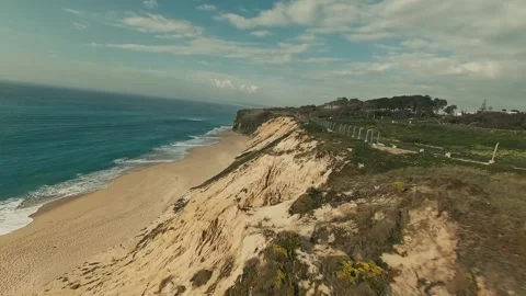 Aerial view glides over rugged cliffs and turquoise ocean Stock Footage 340226184