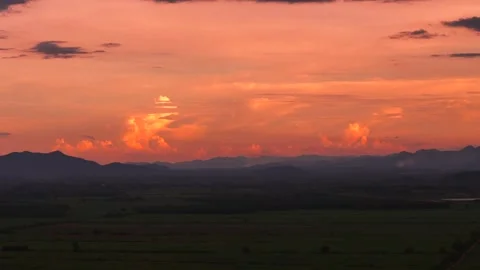 Aerial view of glowing orange sunset over mountain valley and colorful sky Vídeos de archivo 317375117