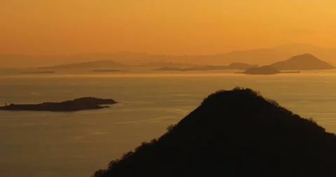 Aerial view of glowing sunset over ocean and island landscape Video stock 333053509