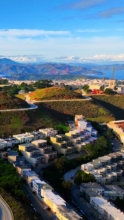 Aerial view of Golden Gate Bridge across a hillside trail, San Francisco Stock Footage 342274435