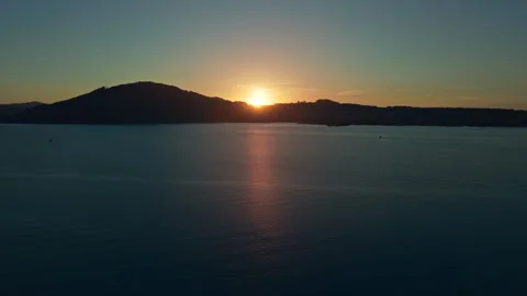 Aerial view of golden sun setting right over mountain skyline at Lake Attersee 库存影片 345611778