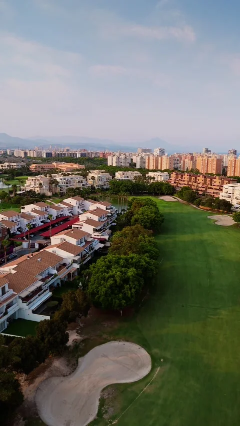 Aerial view of golf course and residential area in Alicante, Spain at sunset Stock Footage 311065765
