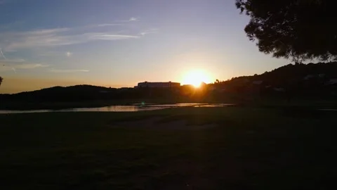 Aerial view of a golf course during sunset hour Vidéo 288107499