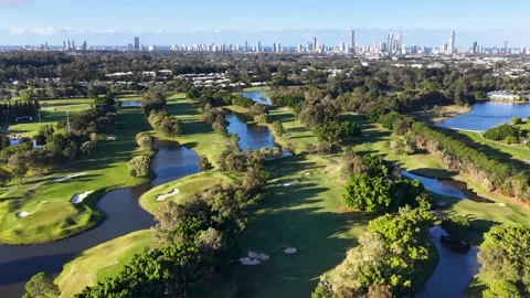 Aerial View of Golf Course Fairways and City Skyline 動画素材 339513533