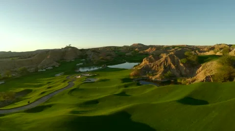 Aerial view of golf course fly over with lens flare Stock Footage 48826687