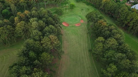 Aerial view of golf course green with sand bunkers surrounded by forest Stock Footage 332432052