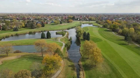 Aerial view of a golf course with ponds. Residential houses next to golf course. Stock Footage 142658606