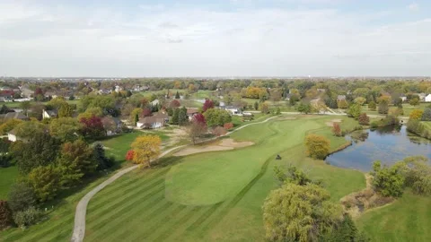 Aerial view of a golf course with ponds. Man fast driving cut grass lawn mower Stock Footage 142659721